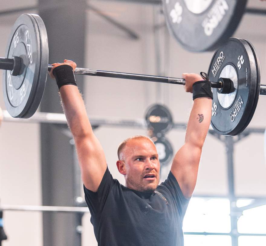 Dr. Alex White locking out an overhead press