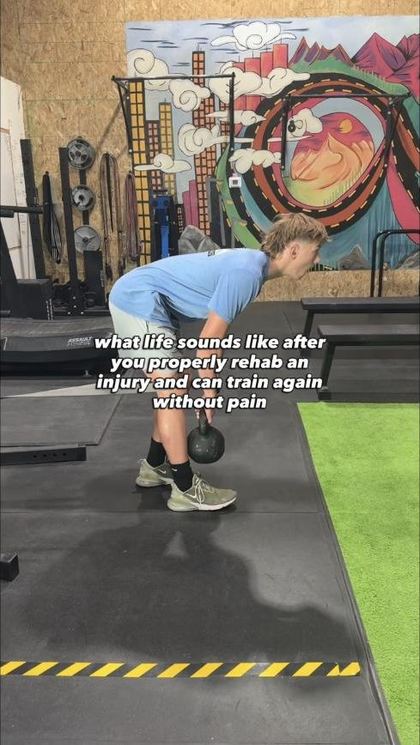 Young athlete performing a kettlebell deadlift during rehab