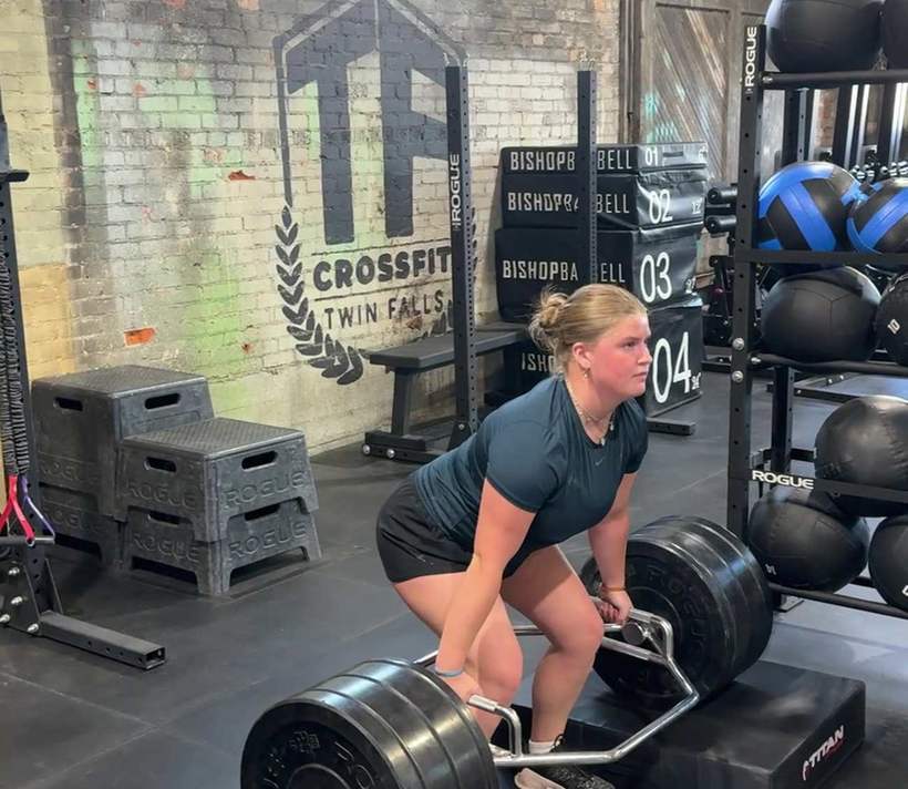 An athlete lifting from a trap bar